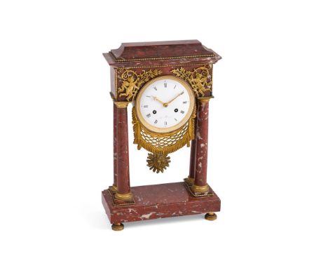 A FRENCH RED MARBLE MANTEL CLOCK MID 19TH CENTURY With eight-day bell striking movement with outside countwheel, the white en