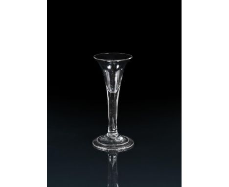 A PLAIN-STEMMED GIN OR DRAM GLASS SECOND QUARTER 18TH CENTURY Of drawn trumpet form with basal tear inclusion and folded coni