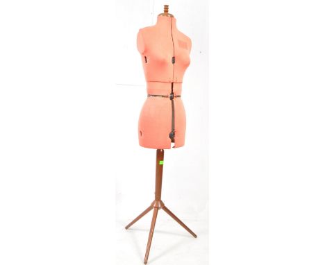 Mid 20th century seamstress shop, haberdashery mannequin. Raised on a teak angular three point base, pink fabric, female form