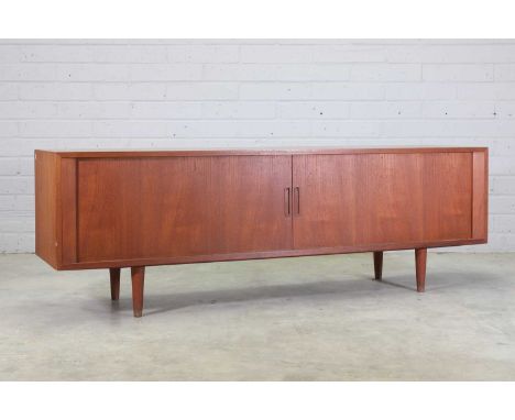 A Danish teak sideboard,1960s, with a tambour front, enclosing three central slides, flanked with a shelf to either side, rai