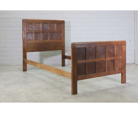 A Robert 'Mouseman' Thompson oak bed frame, 1930s, the headboard and footboard panelled, with half penny moulding to the tops