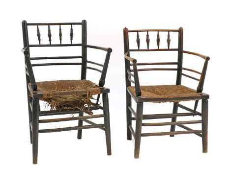 A near pair of Sussex open armchairs, c.1890, designed by Philip Webb for Morris &amp; Co., each backrest with a bobbin-turne