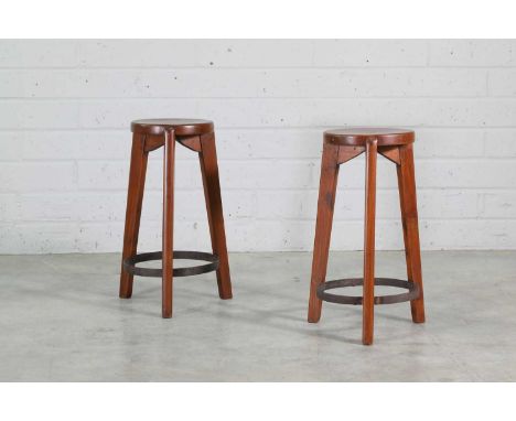 A pair of teak stools, 1965-66, designed by Pierre Jeanneret (1896-1967) for Chandigarh, each with a dished circular seat, ra