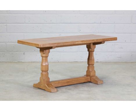 A Robert 'Mouseman' Thompson oak coffee table,with an adzed rectangular top, raised on carved octagonal supports, with a carv