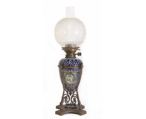 A Doulton Lambeth stoneware oil lamp,1882, incised and cut in low relief with panels of garden rascals, cradled in a metal st