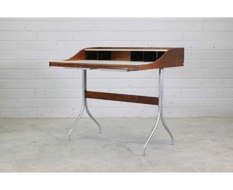 A 'Model 5850' desk, designed by George Nelson for Herman Miller in 1954, with a walnut frame, a laminate raised shelf and wr