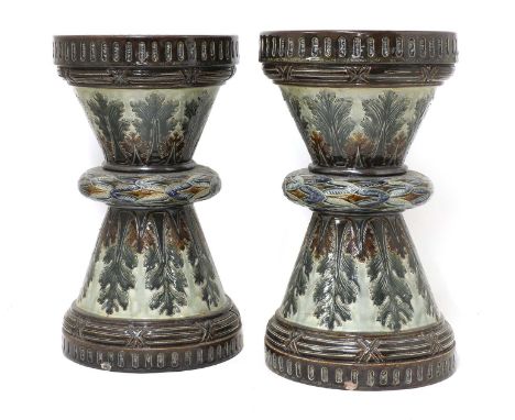 A pair of Doulton Lambeth stoneware garden seats,1884, by George Hugo Tabor, each of hourglass form and centred with a wreath