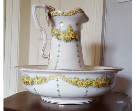 An Early 20th Century Water Jug and Basin with transfer printed yellow foliate decoration.