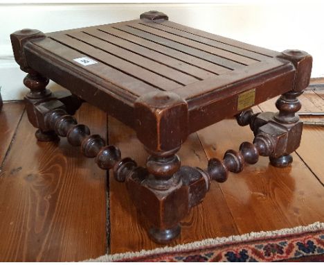 An Oak Stool with Slatted Top having plaque to side reading Made from the timber removed from HMS Britannia'.