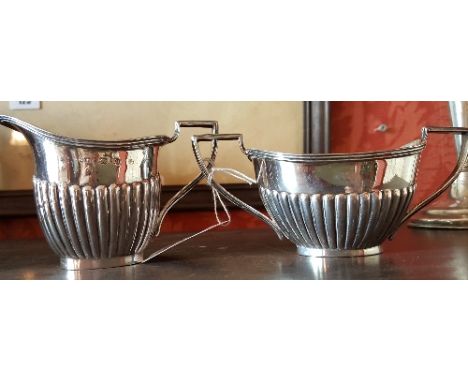 A Silver Cream Jug and Sugar Basin with half reeded decoration. Birmingham 1894, GC Whiles. Approx. 6.89 ozs.