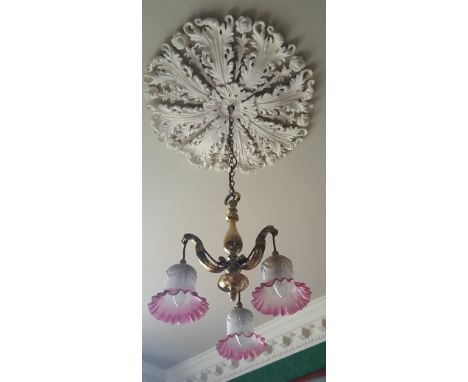 A 19th Century Three-Light Brass Chandelier with frosted opaque to ruby frilled glass shades.