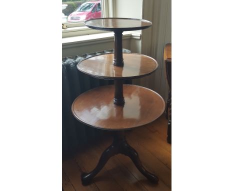 A Georgian Mahogany Three-Tier Dumb Waiter of three tier form with turned stem, dished moulded edged trays, tripod base with 