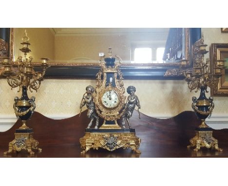 A Large Gilt Metal Mounted Clock Garniture;  in the Empire style, the enamel dial signed Imperial, the 8-day German movement 