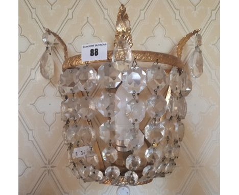 A Gilt Brass Wall Light Fitted with Crystal Drops.