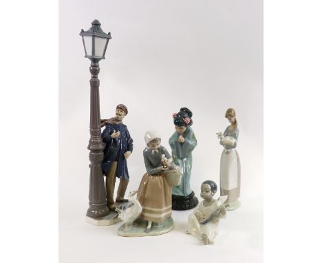 A collection of five Lladro porcelain figures including a man standing beside a street lamp, 47cm high (5).