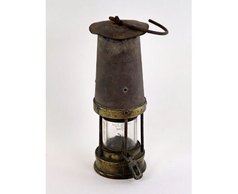 A miners brass mounted lamp, by Davis Kirkby no. 262, early 20th century, with padlock base, 36cm high.