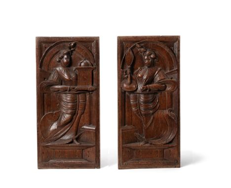 A PAIR OF FLEMISH SCULPTED OAK ALLEGORICAL PANELS17TH CENTURYProbably emblematic of vanity, one woman holding a clock, the ot