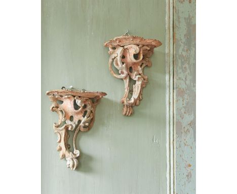 A PAIR OF GEORGE II CARVED SOFT WOOD WALL BRACKETS IN THE MANNER OF THOMAS JOHNSON, CIRCA 1755each 27cm high, 20.5cm wide, 13