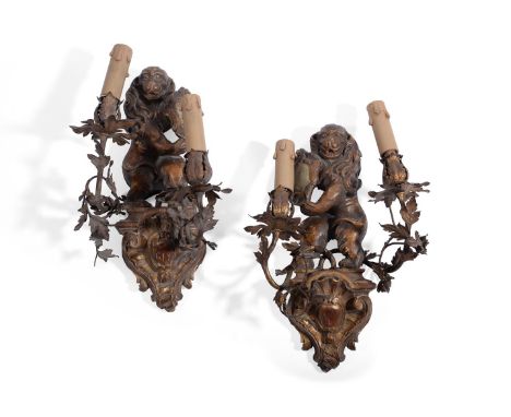 A PAIR OF ITALIAN TWIN-LIGHT GILT METAL WALL SCONCES PROBABLY VENETIAN, SECOND HALF 18TH CENTURY Mounted with carved giltwood