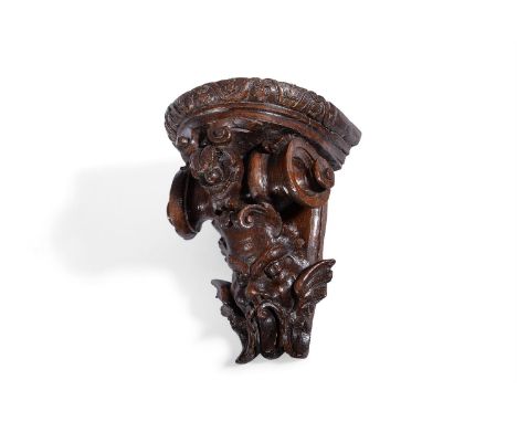 A GEORGE II CARVED OAK WALL BRACKET CIRCA 1730Of winged grotesque mask form21.5cm high, 16cm wide, 13cm deepCondition Report: