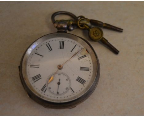 Swiss silver 0.935 open face pocket watch with an engine turned reverse and two winding keys, some damage to the enamel dial 