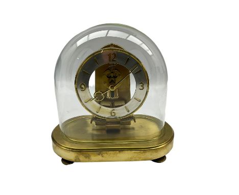 Schatz - German 20th-century battery operated mantle clock, with an oscillating pendulum under an oval glass dome, base with 
