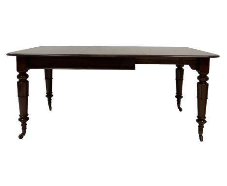 Victorian mahogany pull-out action extending dining table, the extendable top with one additional leaf, raised on turned supp