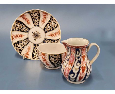 A Chelsea Derby tea bowl and saucer, gilt mark together with a similar Queen Charlotte pattern Worcester jug, RF 151The Worce