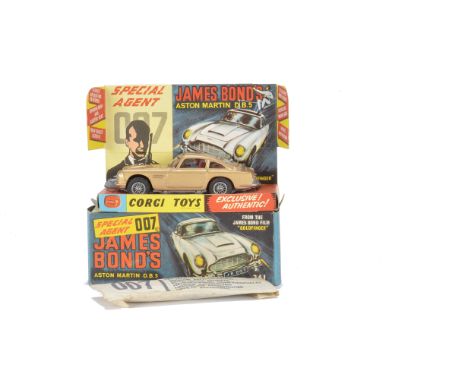 A Corgi Toys 261 James Bond's Aston Martin, gold body, red interior, wire wheels, Bandit figure, in original box with inner s