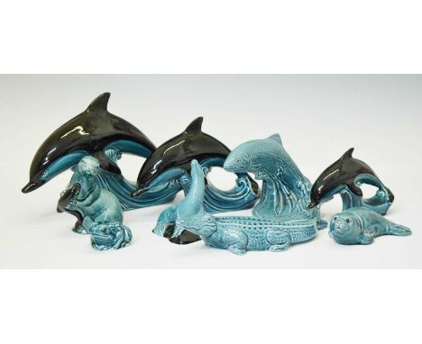 Group of nine Poole pottery animals to include an otter, fish, alligator, and dolphins, 19cm high and smaller (9)