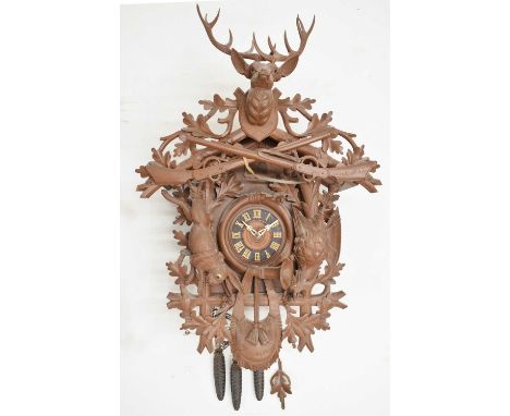 Large 20th century cuckoo clock with carved stag's head surmount over rabbit or hare and bird, all having glass eyes, the cha