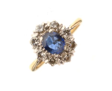 Sapphire and diamond cluster ring, the yellow metal shank stamped '18ct &amp; Plat', the oval cut sapphire 5mm x 6mm approx, 