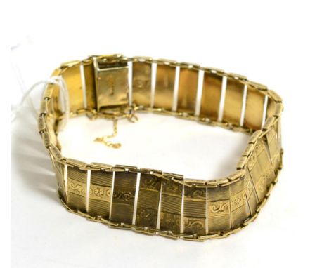 A foliate engraved and engine turned link bracelet, length 20cm, stamped '585'Good condition. Fastens with a tongue and box c