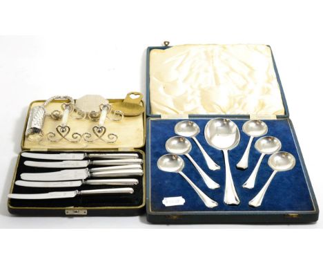 An unusual silver plated bobbin holder; a pair of knife rests; and Arts & Crafts brass caddy spoon; cased tea knives with sil