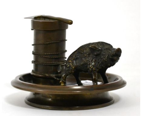 A novelty bronze inkwell, modelled as a boar tethered to a block, the knop for the hinged cover in the form of an axe