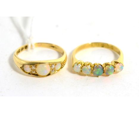 An 18 carat gold opal and diamond ring, three graduated round cut opals spaced by old cut diamond accents, to a tapering shan