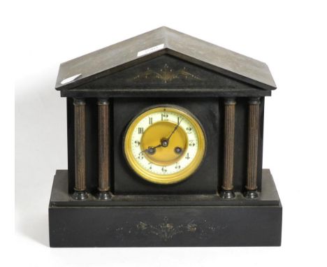 A Victorian slate mantel clock of architectural form, the enamel dial with Arabic numerals 