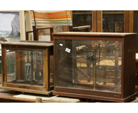 Two glazed panel wooden cased sets of precision Brass scales