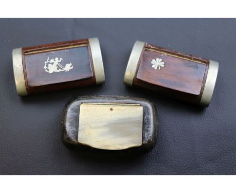 Two wooden and white metal snuff boxes one inlaid with cherub, the other with shamrock and a horn snuff box (3)