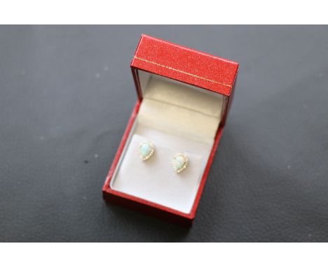 Pair of silver CZ and pear shaped opal stud earrings