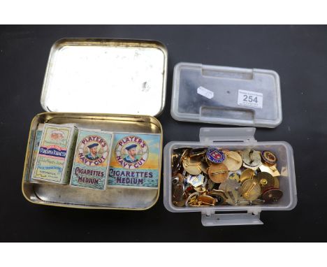 Collection of enamel bowling badges and cigarette cards with vintage cigarette packets