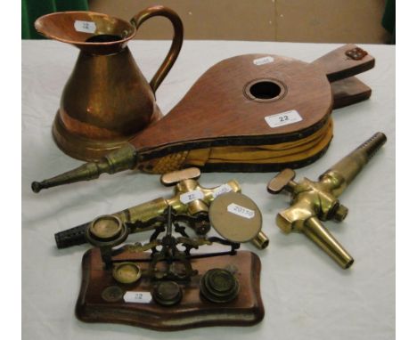 A bellows, beer taps, postage scale and a copper jug.