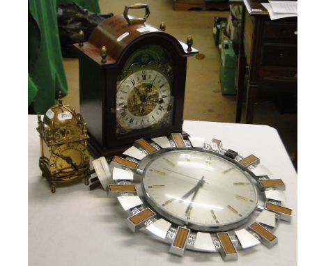 A small brass lantern clock, a Metamec clock and a modern mantel clock.