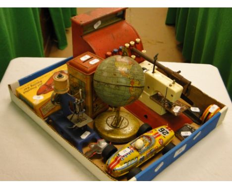A child's toy cash register, sewing machine, globe, etc.