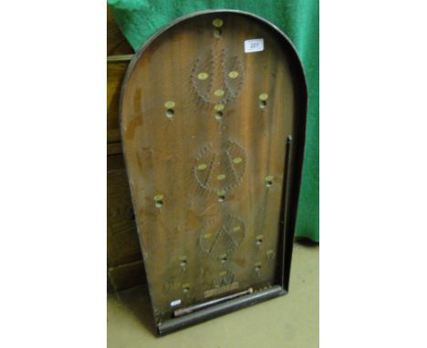 A Corinthian Bagatelle board with balls and cue.