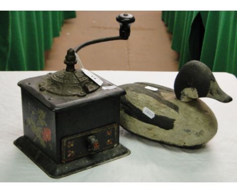 Vintage coffee grinder and a carved and painted wooden duck.