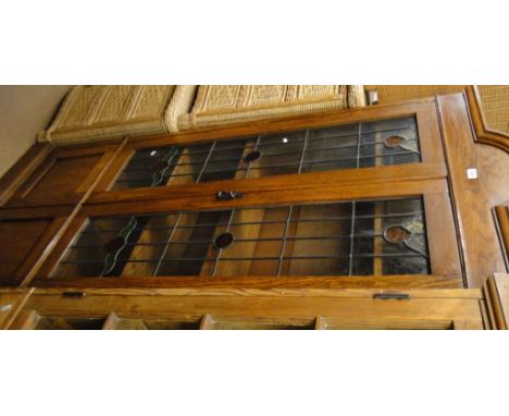 A 1920s oak bookcase with 2 lead light glazed doors, height 6'7".