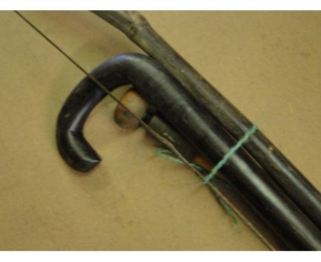A brass shell case, an ebony walking stick, etc.