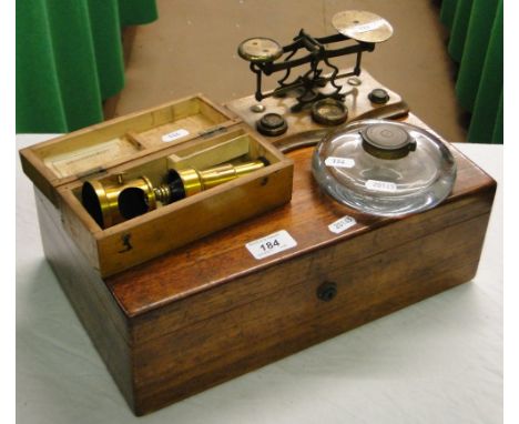 A box with knitting needles, a postal scale, a French microscope and a glass inkwell.