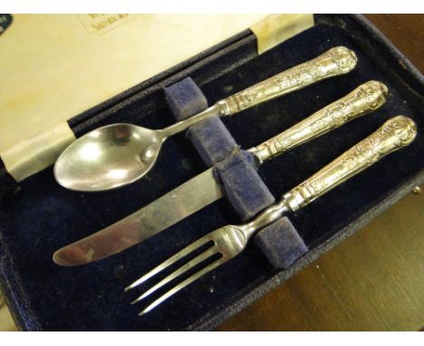 Cased silver handled knife, fork and spoon set.